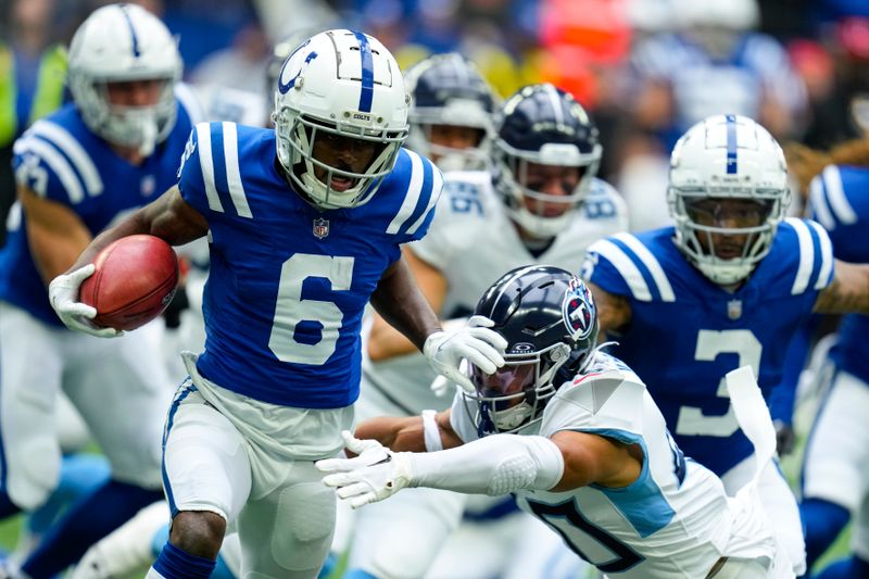 Indianapolis Colts wide receiver Isaiah McKenzie (6) stiff arms Tennessee Titans cornerback Anthony Kendall, right, during the first half of an NFL football game, Sunday, Oct. 8, 2023, in Indianapolis. (AP Photo/Michael Conroy)