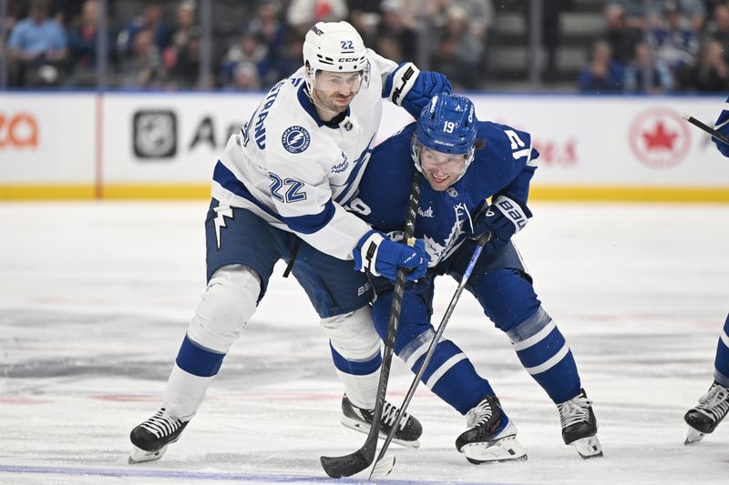 Mar 7, 2026; Toronto, Ontario, CAN; Tampa Bay Lightning forward Oliver Bjorkstrand (22) battles for position against Toronto Maple Leafs forward Calle Jarnkrok (19) in the first period at Scotiabank Arena. Mandatory Credit: Dan Hamilton-Imagn Images