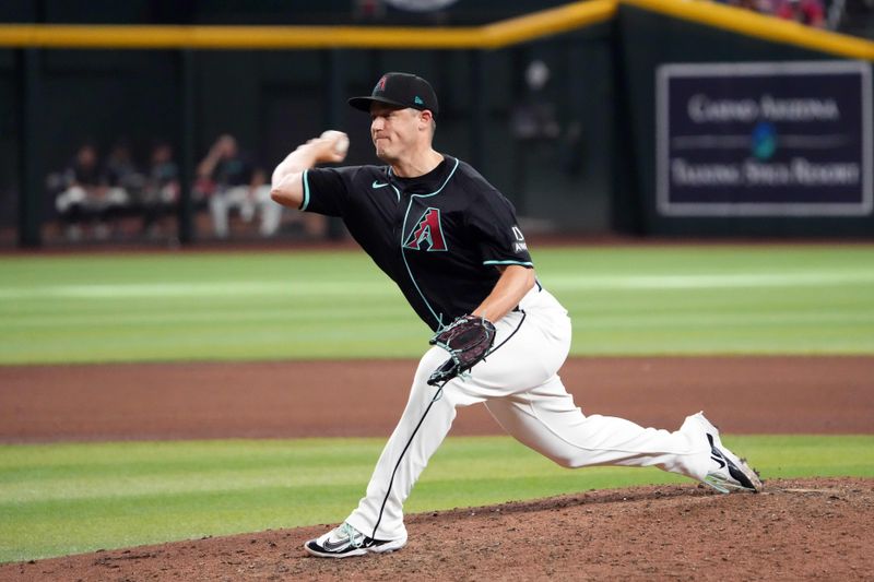 Jun 30, 2024; Phoenix, Arizona, USA; Arizona Diamondbacks pitcher Paul Sewald (38) pitches against the Oakland Athletics during the ninth inning at Chase Field. Mandatory Credit: Joe Camporeale-USA TODAY Sports