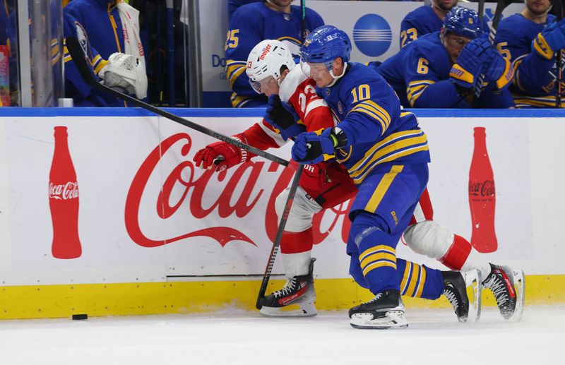 Dec 5, 2023; Buffalo, New York, USA;  Buffalo Sabres defenseman Henri Jokiharju (10) checks Detroit Red Wings left wing Lucas Raymond (23) as he goes after the puck during the third period at KeyBank Center. Mandatory Credit: Timothy T. Ludwig-USA TODAY Sports