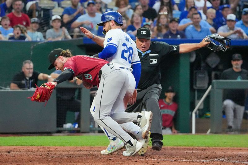 Jul 24, 2024; Kansas City, Missouri, USA; Arizona Diamondbacks pitcher Ryne Nelson (19) misses the tag as Kansas City Royals center fielder Kyle Isbel (28) scores on a wild pitch in the fourth inning at Kauffman Stadium. Mandatory Credit: Denny Medley-USA TODAY Sports