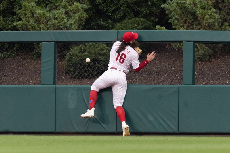 Aug 5, 2023; Philadelphia, Pennsylvania, USA; Philadelphia Phillies center fielder Brandon Marsh (16) is injured while attempting to catch the triple of Kansas City Royals second baseman Samad Taylor (not pictured) during the fifth inning at Citizens Bank Park. Mandatory Credit: Bill Streicher-USA TODAY Sports