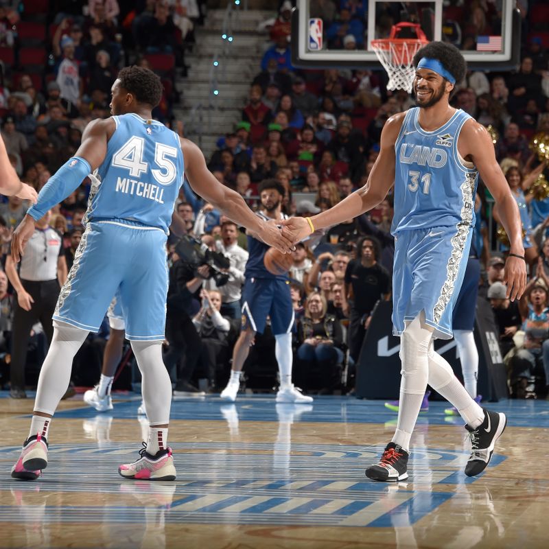 CLEVELAND, OH - DECEMBER 8: Donovan Mitchell #45 and Jarrett Allen #31 of the Cleveland Cavaliers high five during the game against the Denver Nuggets on December 5, 2024 at Rocket Mortgage FieldHouse in Cleveland, Ohio. NOTE TO USER: User expressly acknowledges and agrees that, by downloading and/or using this Photograph, user is consenting to the terms and conditions of the Getty Images License Agreement. Mandatory Copyright Notice: Copyright 2024 NBAE (Photo by David Liam Kyle/NBAE via Getty Images)