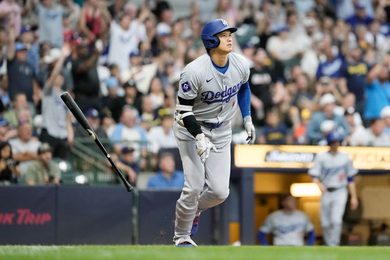 Aug 13, 2024; Milwaukee, Wisconsin, USA;  Los Angeles Dodgers designated hitter Shohei Ohtani (17) flips his bat away after hitting a home run during the third inning against the Milwaukee Brewers at American Family Field. Mandatory Credit: Jeff Hanisch-USA TODAY Sports