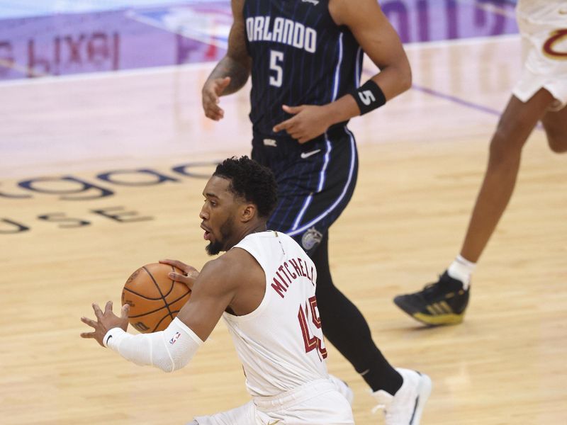 CLEVELAND, OH - APRIL 22: Donovan Mitchell #45 of the Cleveland Cavaliers dribbles the ball during the game against the Orlando Magic during Round 1 Game 2 of the 2024 NBA Playoffs on April 22, 2024 at Rocket Mortgage FieldHouse in Cleveland, Ohio. NOTE TO USER: User expressly acknowledges and agrees that, by downloading and/or using this Photograph, user is consenting to the terms and conditions of the Getty Images License Agreement. Mandatory Copyright Notice: Copyright 2024 NBAE (Photo by Lauren Leigh Bacho/NBAE via Getty Images)