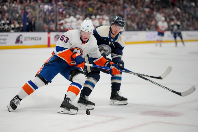 Apr 4, 2024; Columbus, Ohio, USA;  New York Islanders center Casey Cizikas (53) skates for the puck against Columbus Blue Jackets center Cole Sillinger (4) in the third period at Nationwide Arena. Mandatory Credit: Aaron Doster-USA TODAY Sports