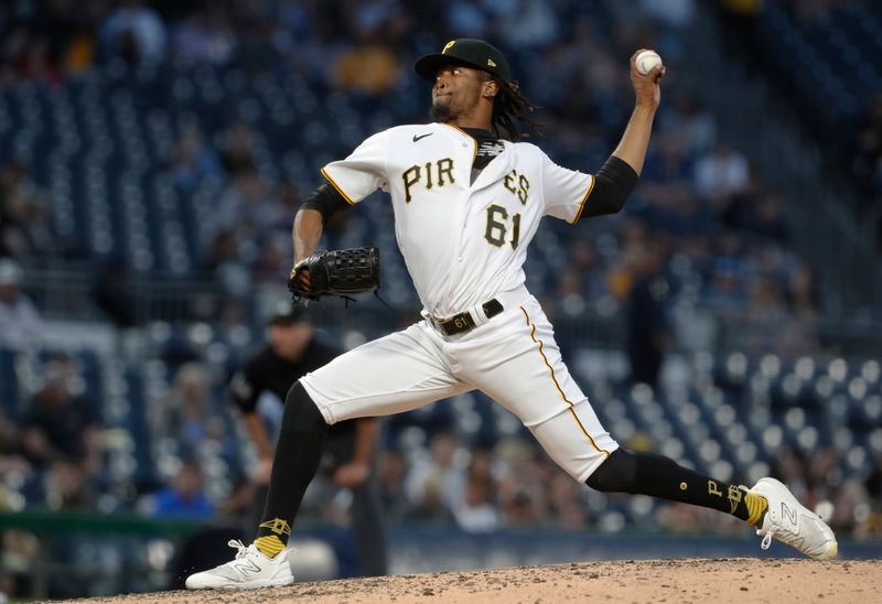 May 9, 2023; Pittsburgh, Pennsylvania, USA;  Pittsburgh Pirates relief pitcher Jose Hernandez (61) pitches against the Colorado Rockies during the seventh inning at PNC Park. Mandatory Credit: Charles LeClaire-USA TODAY Sports