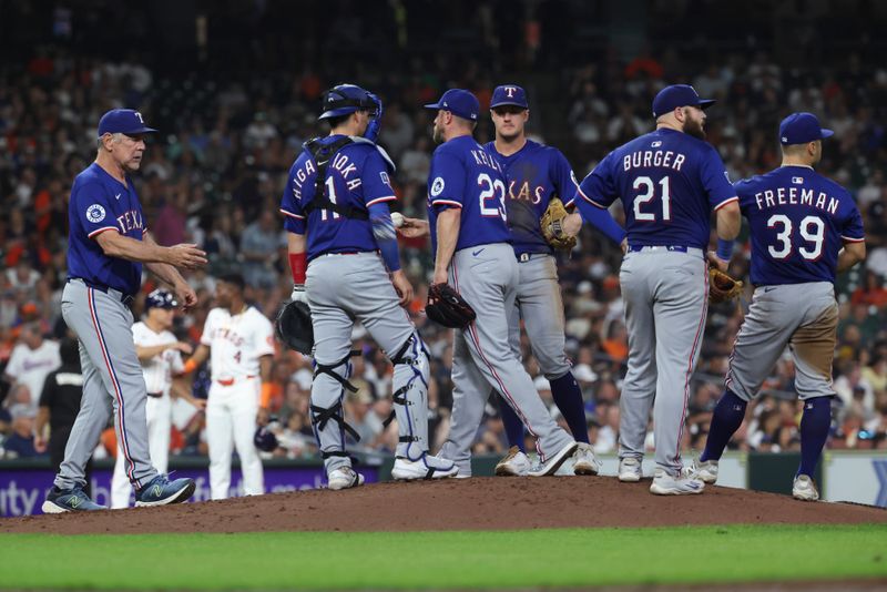 Sep 16, 2025; Houston, Texas, USA; Texas Rangers manager Bruce Bochy (15) takes the ball from starting pitcher Merrill Kelly (23) during a pitching change in the fourth inning against the Houston Astros at Daikin Park. Mandatory Credit: Troy Taormina-Imagn Images