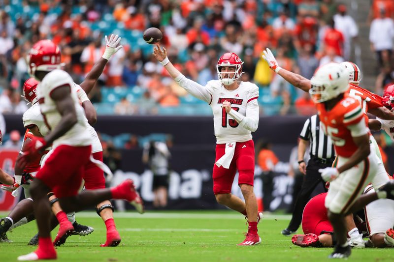 Nov 18, 2023; Miami Gardens, Florida, USA; Louisville Cardinals quarterback Jack Plummer (13) throws the football against the Miami Hurricanes during the second quarter at Hard Rock Stadium. Mandatory Credit: Sam Navarro-USA TODAY Sports