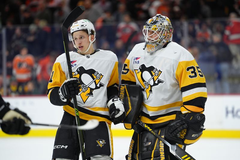 Dec 1, 2025; Philadelphia, Pennsylvania, USA; Pittsburgh Penguins center Ben Kindel (81) reacts with goalie Tristan Jarry (35) against the Philadelphia Flyers after the first period at Xfinity Mobile Arena. Mandatory Credit: Kyle Ross-Imagn Images
