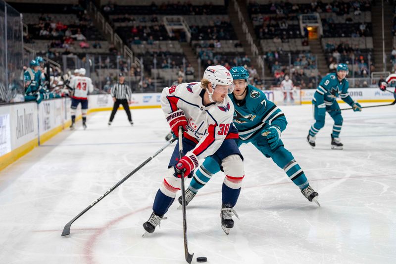 Nov 27, 2023; San Jose, California, USA; Washington Capitals defenseman Rasmus Sandin (38) controls the puck against San Jose Sharks center Nico Sturm (7) during the third period at SAP Center at San Jose. Mandatory Credit: Neville E. Guard-USA TODAY Sports