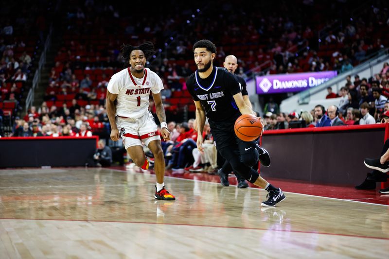 Dec 20, 2023; Raleigh, North Carolina, USA; Saint Louis Billikens guard Michael Meadows Jr. (7) dribbles with the ball guarded by North Carolina State Wolfpack guard Jayden Taylor (1) during the second half at PNC Arena. Mandatory Credit: Jaylynn Nash-USA TODAY Sports