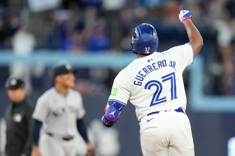 Jun 27, 2024; Toronto, Ontario, CAN; Toronto Blue Jays first baseman Vladimir Guerrero Jr. (27) celebrates his solo home run against the New York Yankees as he runs to second base during the sixth inning at Rogers Centre. Mandatory Credit: John E. Sokolowski-USA TODAY Sports