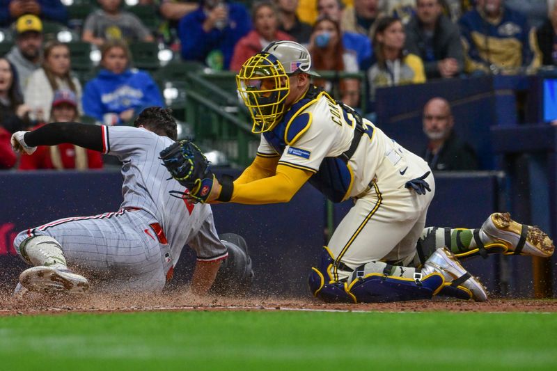 May 17, 2025; Milwaukee, Wisconsin, USA; Milwaukee Brewers catcher William Contreras (24) tags out ]Minnesota Twins shortstop Brooks Lee (2) trying to score in the third inning at American Family Field. Mandatory Credit: Benny Sieu-Imagn Images