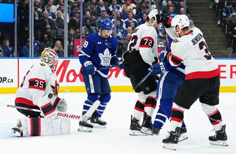 Nov 12, 2024; Toronto, Ontario, CAN; Ottawa Senators goaltender Linus Ullmark (35) stops a puck as Toronto Maple Leafs left wing Matthew Knies (23) looks for the rebound during the third period at Scotiabank Arena. Mandatory Credit: Nick Turchiaro-Imagn Images