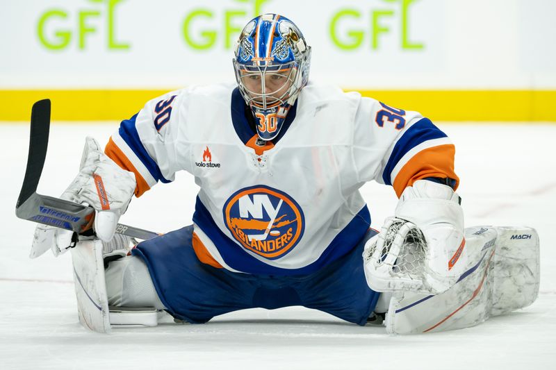 Dec 8, 2024; Ottawa, Ontario, CAN; New York Islanders goalie Ilya  Sorokin (30) stretches during a break in hte first period against the Ottawa Senators at the Canadian Tire Centre. Mandatory Credit: Marc DesRosiers-Imagn Images