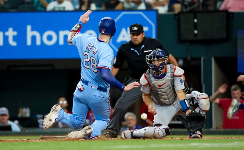 Jul 23, 2023; Arlington, Texas, USA;  Texas Rangers catcher Jonah Heim (28) scores ahead of the tag by Los Angeles Dodgers catcher Austin Barnes (15) during the fourth inning at Globe Life Field. Mandatory Credit: Kevin Jairaj-USA TODAY Sports