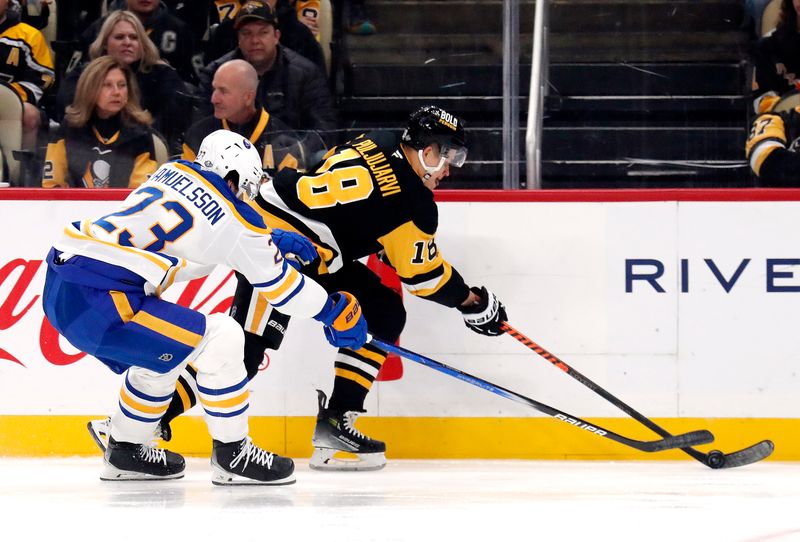 Oct 16, 2024; Pittsburgh, Pennsylvania, USA; Pittsburgh Penguins right wing Jesse Puljujarvi (18) moves the puck against Buffalo Sabres defenseman Mattias Samuelsson (23) during the third period at PPG Paints Arena. Mandatory Credit: Charles LeClaire-Imagn Images