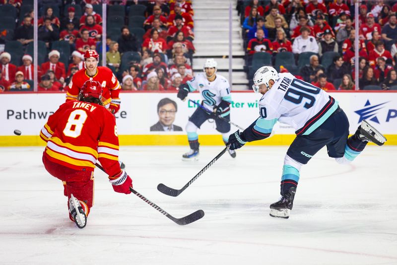 Dec 27, 2023; Calgary, Alberta, CAN; Seattle Kraken left wing Tomas Tatar (90) shoot the puck against Calgary Flames during the first period at Scotiabank Saddledome. Mandatory Credit: Sergei Belski-USA TODAY Sports