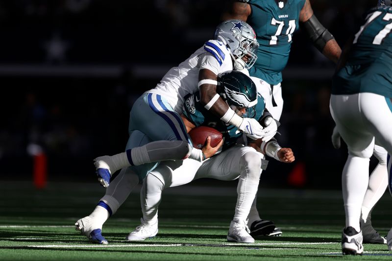 Philadelphia Eagles quarterback Jalen Hurts (1) is sacked by Dallas Cowboys linebacker DeMarvion Overshown in the first half of an NFL football game in Arlington, Texas, Sunday, Nov. 10, 2024. (AP Photo/Gareth Patterson)