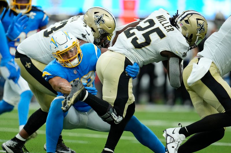 Los Angeles Chargers linebacker Blake Lynch (53) tackles New Orleans Saints running back Kendre Miller (25) in the first half of an NFL football game in Inglewood, Calif., Sunday, Aug. 20, 2023. (AP Photo/Marcio Jose Sanchez)