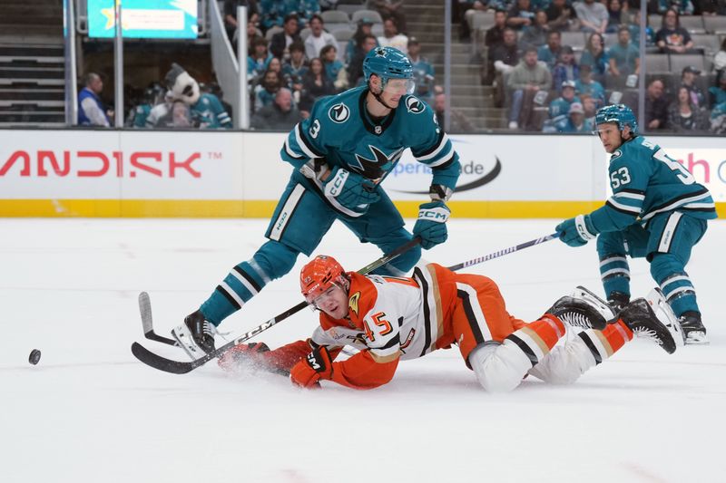 Oct 11, 2025; San Jose, California, USA; Anaheim Ducks right wing Beckett Sennecke (45) falls to the ice against San Jose Sharks defenseman John Klingberg (3) during the first period at SAP Center at San Jose. Mandatory Credit: Darren Yamashita-Imagn Images