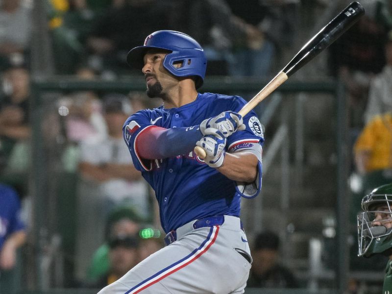 Apr 22, 2025; West Sacramento, California, USA; Texas Rangers second baseman Marcus Semien (2) hits a home run against the Athletics during the fifth inning at Sutter Health Park. Mandatory Credit: Ed Szczepanski-Imagn Images