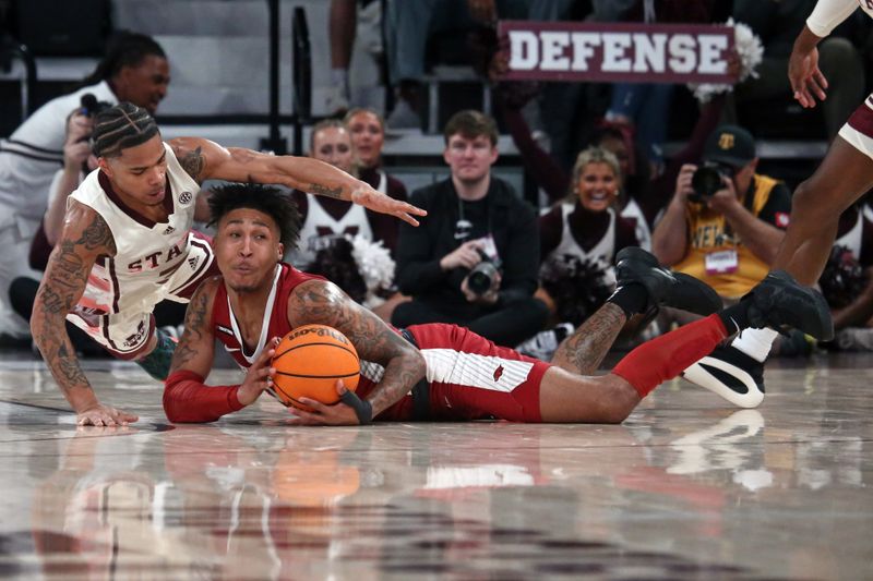 Feb 17, 2024; Starkville, Mississippi, USA; Mississippi State Bulldogs guard Shakeel Moore (3) and Arkansas Razorbacks guard Jeremiah Davenport (24) battle for a loose ball during the first half at Humphrey Coliseum. Mandatory Credit: Petre Thomagainst-USA TODAY Sports