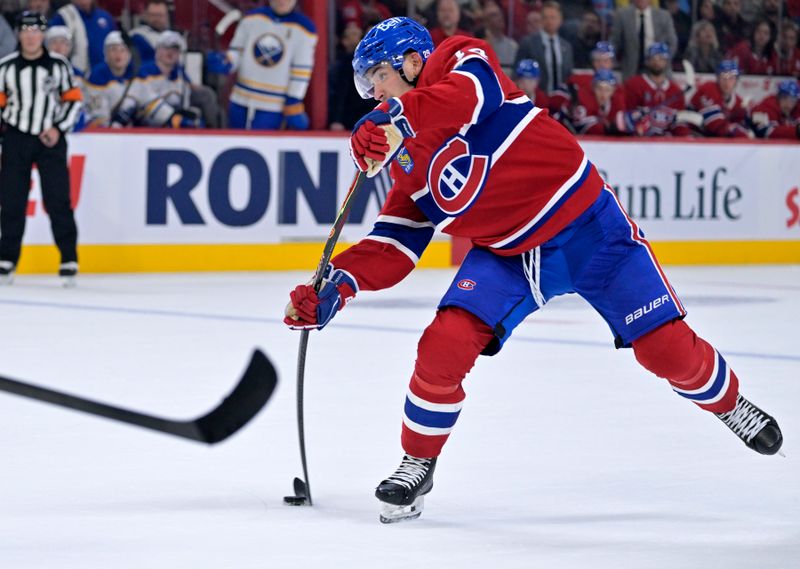 Oct 20, 2025; Montreal, Quebec, CAN; Montreal Canadiens forward Nick Suzuki (14) shoots the puck on net during the first period of the game against the Buffalo Sabres at the Bell Centre. Mandatory Credit: Eric Bolte-Imagn Images