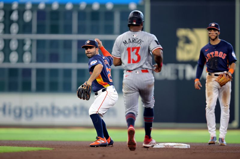 Jun 1, 2024; Houston, Texas, USA; Houston Astros second baseman Jose Altuve (27) throws the ball to first base to complete a double play against the Minnesota Twins during the fourth inning at Minute Maid Park. Mandatory Credit: Erik Williams-USA TODAY Sports