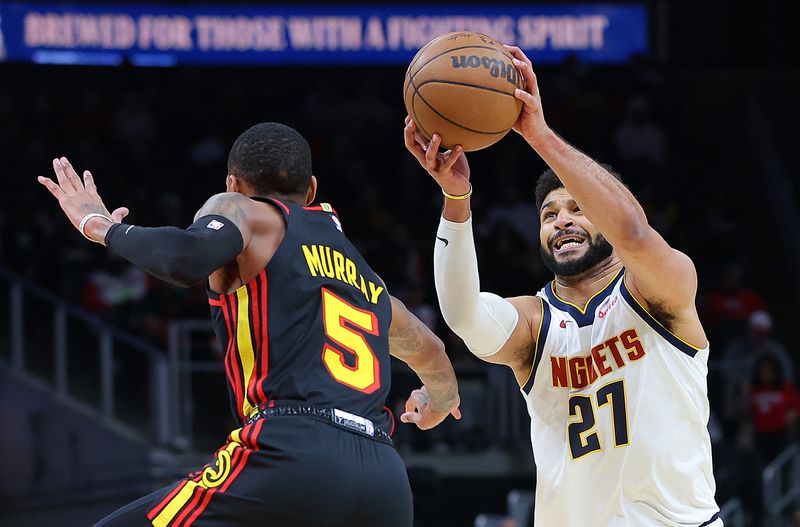 ATLANTA, GEORGIA - DECEMBER 11:  Jamal Murray #27 of the Denver Nuggets grabs a loose ball against Dejounte Murray #5 of the Atlanta Hawks during the first quarter at State Farm Arena on December 11, 2023 in Atlanta, Georgia.  NOTE TO USER: User expressly acknowledges and agrees that, by downloading and/or using this photograph, user is consenting to the terms and conditions of the Getty Images License Agreement.  (Photo by Kevin C. Cox/Getty Images)