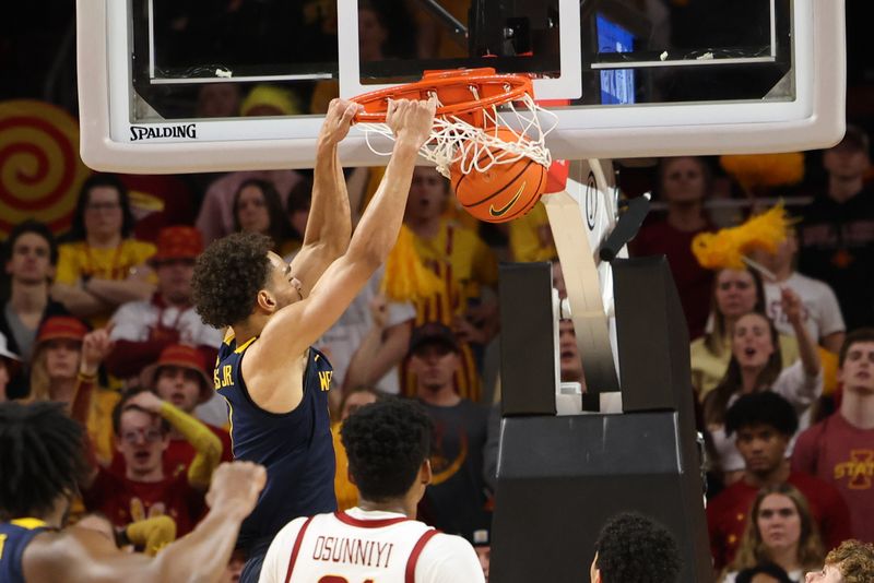 Feb 27, 2023; Ames, Iowa, USA; West Virginia Mountaineers forward Emmitt Matthews Jr. (1) scores against the Iowa State Cyclones during the second half at James H. Hilton Coliseum. Mandatory Credit: Reese Strickland-USA TODAY Sports