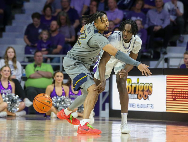 Feb 26, 2024; Manhattan, Kansas, USA; Kansas State Wildcats forward Arthur Maluma (24) passes the ball away from West Virginia Mountaineers forward Josiah Harris (22) during the second half at Bramlage Coliseum. Mandatory Credit: Scott Sewell-USA TODAY Sports