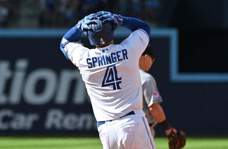 Aug 27, 2023; Toronto, Ontario, CAN; Toronto Blue Jays right fielder George Springer (4) reacts after his fly ball to the center field wall is caught by Cleveland Guardians center fielder Myles Straw (not pictured) in the eighth  inning at Rogers Centre. Mandatory Credit: Dan Hamilton-USA TODAY Sports