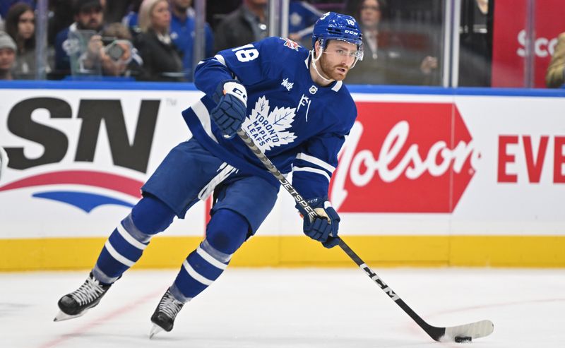 Oct 14, 2023; Toronto, Ontario, CAN;  Toronto Maple Leafs forward Noah Gregor (18) looks to make a pass against the Minnesota Wild in the second period at Scotiabank Arena. Mandatory Credit: Dan Hamilton-USA TODAY Sports