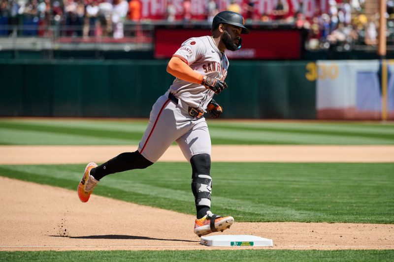 Aug 18, 2024; Oakland, California, USA; San Francisco Giants outfielder Heliot Ramos (17) runs the bases after hitting a one run home run against the Oakland Athletics during the seventh inning at Oakland-Alameda County Coliseum. Mandatory Credit: Robert Edwards-USA TODAY Sports