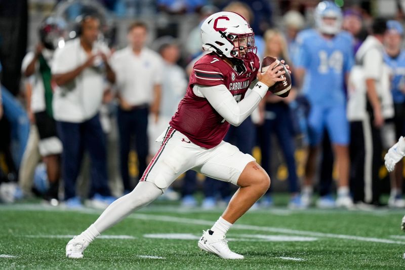 Sep 2, 2023; Charlotte, North Carolina, USA;South Carolina Gamecocks quarterback Spencer Rattler (7) decides to run during the second half against the North Carolina Tar Heels at Bank of America Stadium. Mandatory Credit: Jim Dedmon-USA TODAY Sports