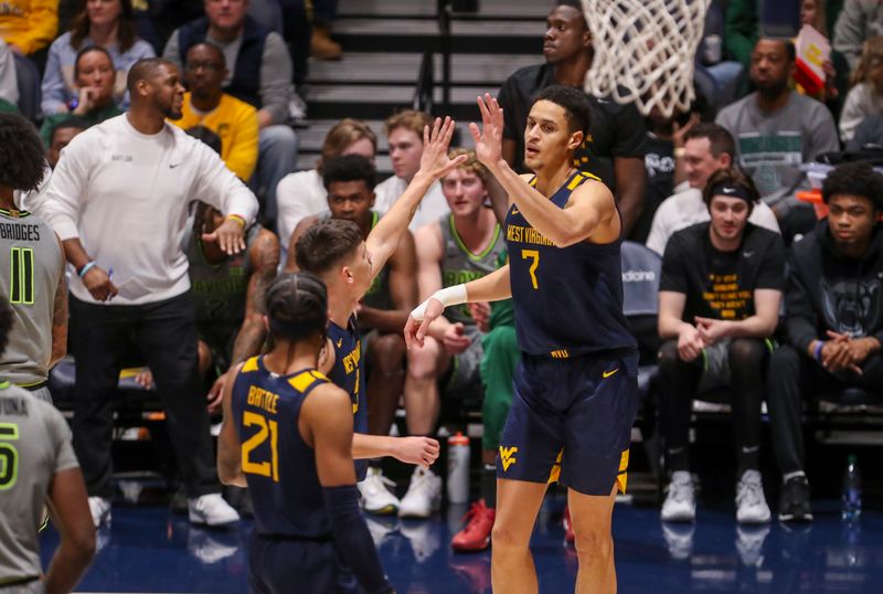 Feb 17, 2024; Morgantown, West Virginia, USA; West Virginia Mountaineers center Jesse Edwards (7) celebrates with West Virginia Mountaineers guard Kerr Kriisa (3) during the second half against the Baylor Bears at WVU Coliseum. Mandatory Credit: Ben Queen-USA TODAY Sports