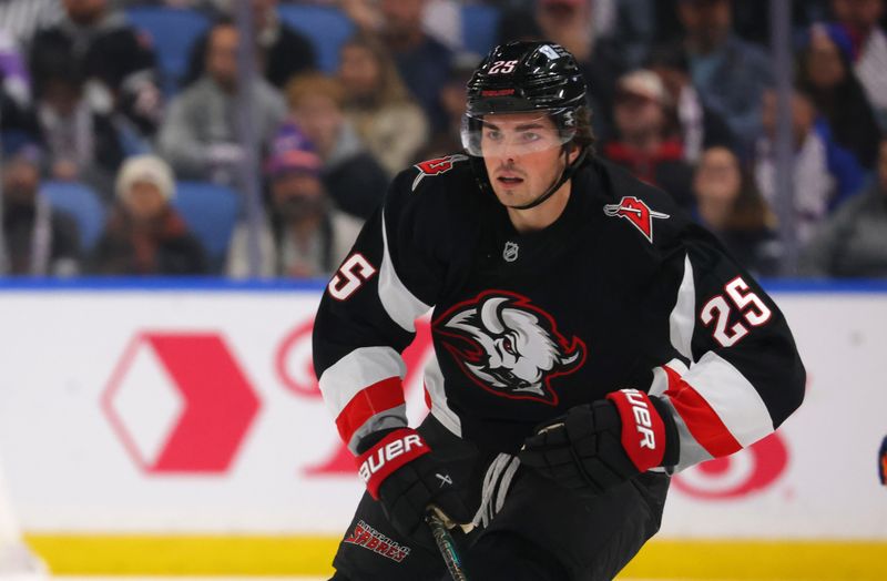 Nov 1, 2024; Buffalo, New York, USA;  Buffalo Sabres defenseman Owen Power (25) looks for the puck during the first period against the New York Islanders at KeyBank Center. Mandatory Credit: Timothy T. Ludwig-Imagn Images