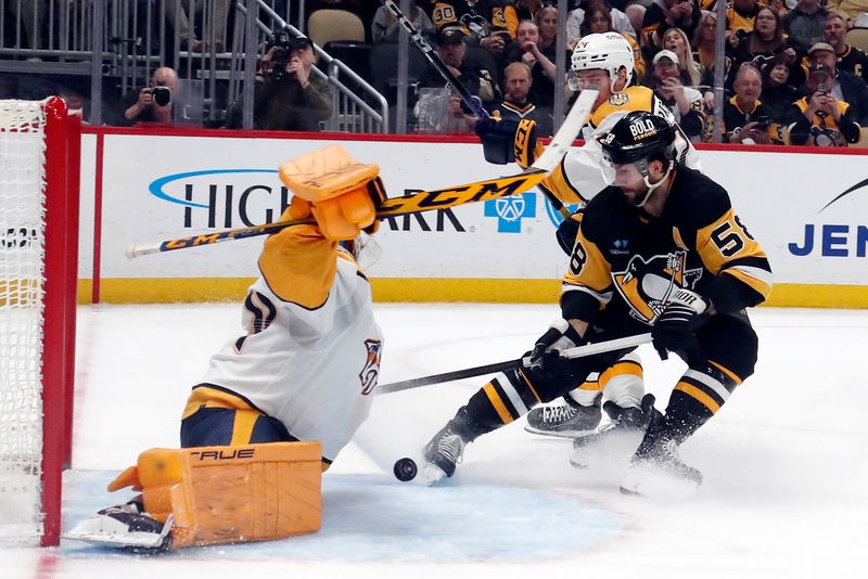 Apr 15, 2024; Pittsburgh, Pennsylvania, USA;  Nashville Predators goaltender Juuse Saros (left) makes a save against Pittsburgh Penguins defenseman Kris Letang (58) during the third period at PPG Paints Arena. The Penguins won 4-2. Mandatory Credit: Charles LeClaire-USA TODAY Sports