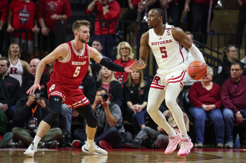 Feb 10, 2024; Piscataway, New Jersey, USA; Rutgers Scarlet Knights forward Aundre Hyatt (5) dribbles the ball against Wisconsin Badgers forward Tyler Wahl (5) during the first half at Jersey Mike's Arena. Mandatory Credit: Vincent Carchietta-USA TODAY Sports