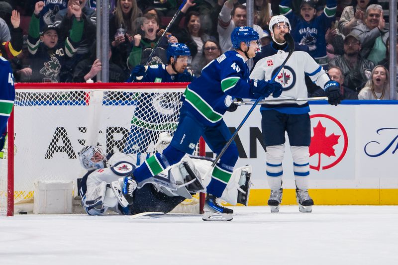 Mar 9, 2024; Vancouver, British Columbia, CAN; Winnipeg Jets defenseman Dylan DeMelo (2) watches as Vancouver Canucks forward Elias Pettersson (40) celebrates a goal scored by forward Nils Hoglander (21) on Winnipeg Jets goalie Connor Hellebuyck (37) in the first period at Rogers Arena. Mandatory Credit: Bob Frid-USA TODAY Sports