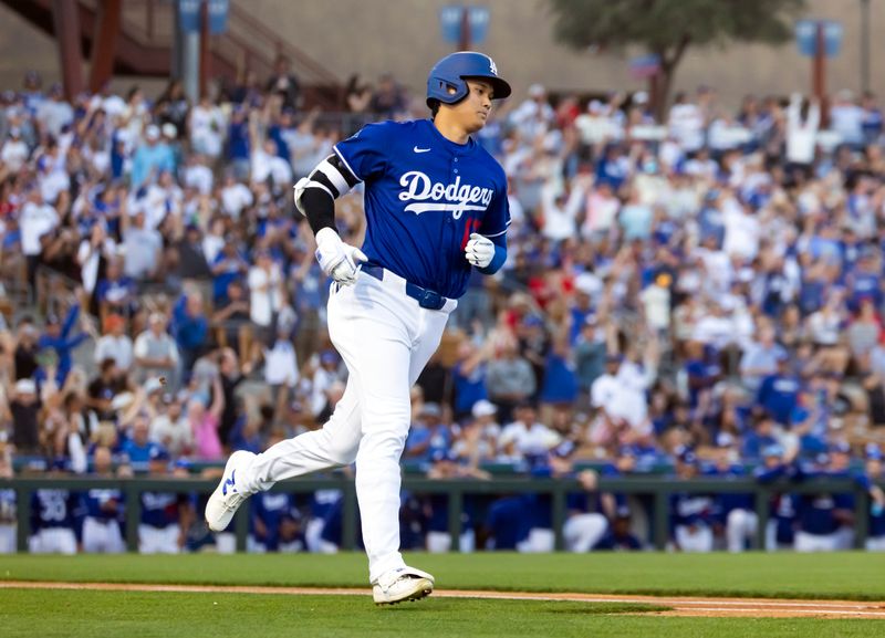 Feb 28, 2025; Phoenix, Arizona, USA; Los Angeles Dodgers designated hitter Shohei Ohtani (17) rounds the bases after hitting a leadoff home run against the Los Angeles Angels during a spring training game at Camelback Ranch-Glendale. Mandatory Credit: Mark J. Rebilas-Imagn Images