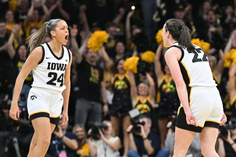 Mar 3, 2024; Iowa City, Iowa, USA; Iowa Hawkeyes guard Caitlin Clark (22) and guard Gabbie Marshall (24) react during the first quarter against the Ohio State Buckeyes at Carver-Hawkeye Arena. Mandatory Credit: Jeffrey Becker-USA TODAY Sports