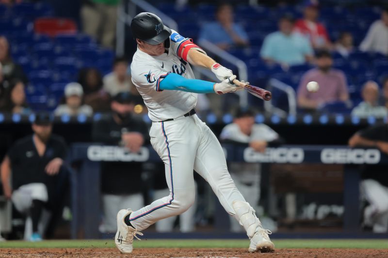 Jun 3, 2025; Miami, Florida, USA; Miami Marlins first baseman Eric Wagaman (33) hits a single against the Colorado Rockies during the sixth inning at loanDepot Park. Mandatory Credit: Sam Navarro-Imagn Images