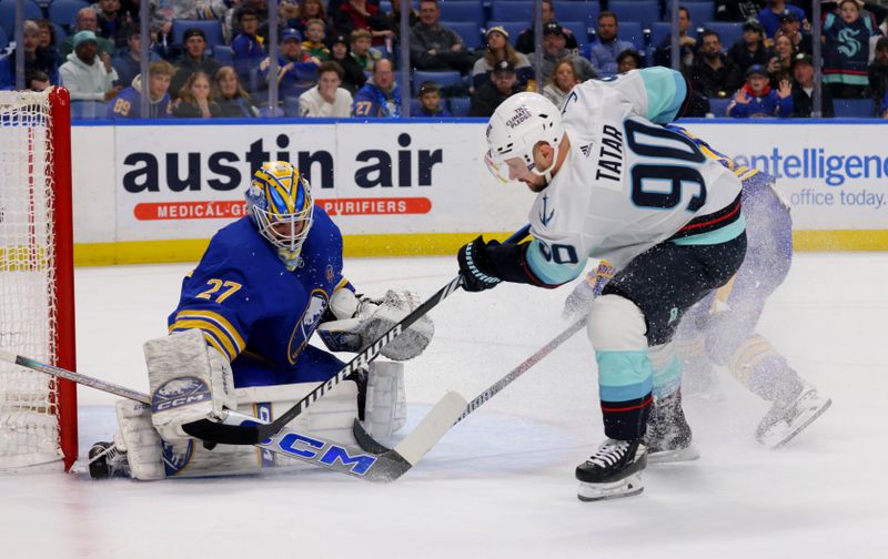 Jan 9, 2024; Buffalo, New York, USA;  Buffalo Sabres goaltender Devon Levi (27) makes a save on Seattle Kraken left wing Tomas Tatar (90) during the first period at KeyBank Center. Mandatory Credit: Timothy T. Ludwig-USA TODAY Sports