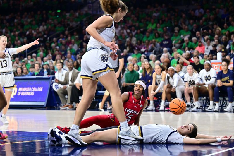 Mar 3, 2024; South Bend, Indiana, USA; Louisville Cardinals guard Nina Rickards (15) is called for an offensive foul while defended by Notre Dame Fighting Irish guard Sonia Citron (11, on floor) in the first half at the Purcell Pavilion. Mandatory Credit: Matt Cashore-USA TODAY Sports