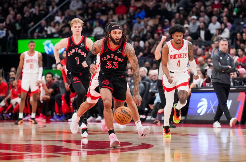 TORONTO, ON - FEBRUARY 9: Gary Trent Jr. #33 of the Toronto Raptors dribbles against Dillon Brooks #9 of the Houston Rockets during the first half of their basketball game at the Scotiabank Arena on February 9, 2024 in Toronto, Ontario, Canada. NOTE TO USER: User expressly acknowledges and agrees that, by downloading and/or using this Photograph, user is consenting to the terms and conditions of the Getty Images License Agreement. (Photo by Mark Blinch/Getty Images)