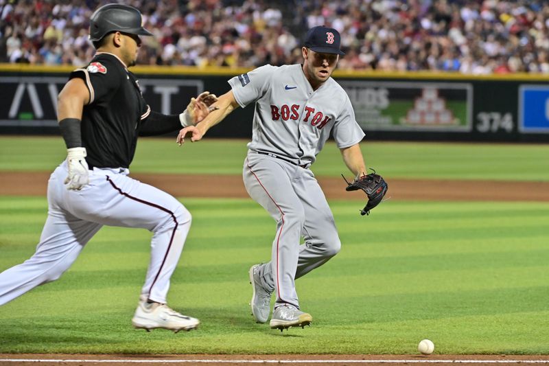 May 27, 2023; Phoenix, Arizona, USA;  Boston Red Sox relief pitcher Kutter Crawford (50) fields a ball as Arizona Diamondbacks catcher Gabriel Moreno (14) runs to first base in the eighth inning at Chase Field. Mandatory Credit: Matt Kartozian-USA TODAY Sports