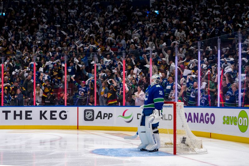 Apr 21, 2024; Vancouver, British Columbia, CAN;  Vancouver Canucks goalie Thatcher Demko (35) watches the Canucks celebrate a goal score by forward Elias Lindholm (23) against the Nashville Predators in the second period in game one of the first round of the 2024 Stanley Cup Playoffs at Rogers Arena. Mandatory Credit: Bob Frid-USA TODAY Sports